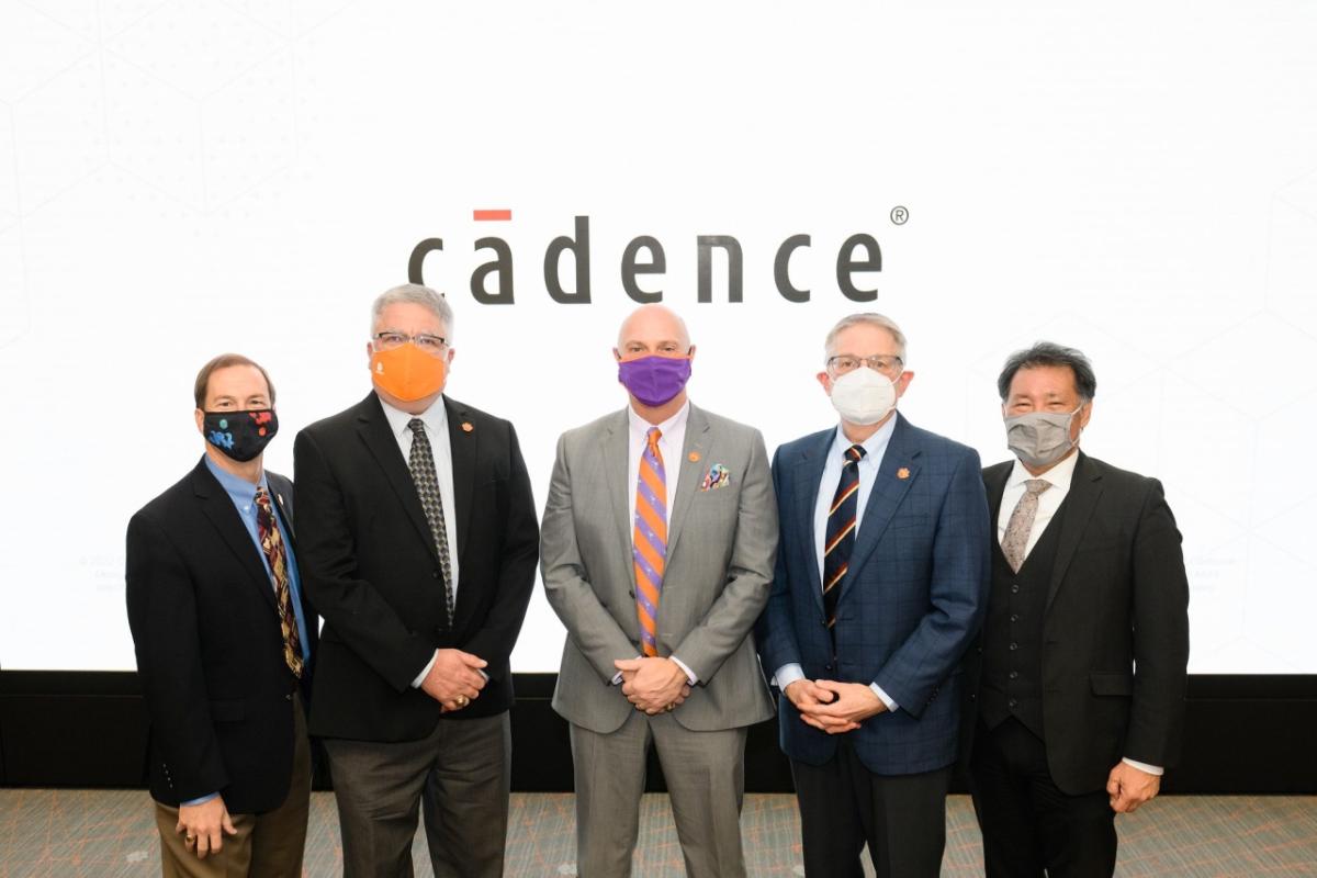 5 people standing in front of the cadence logo