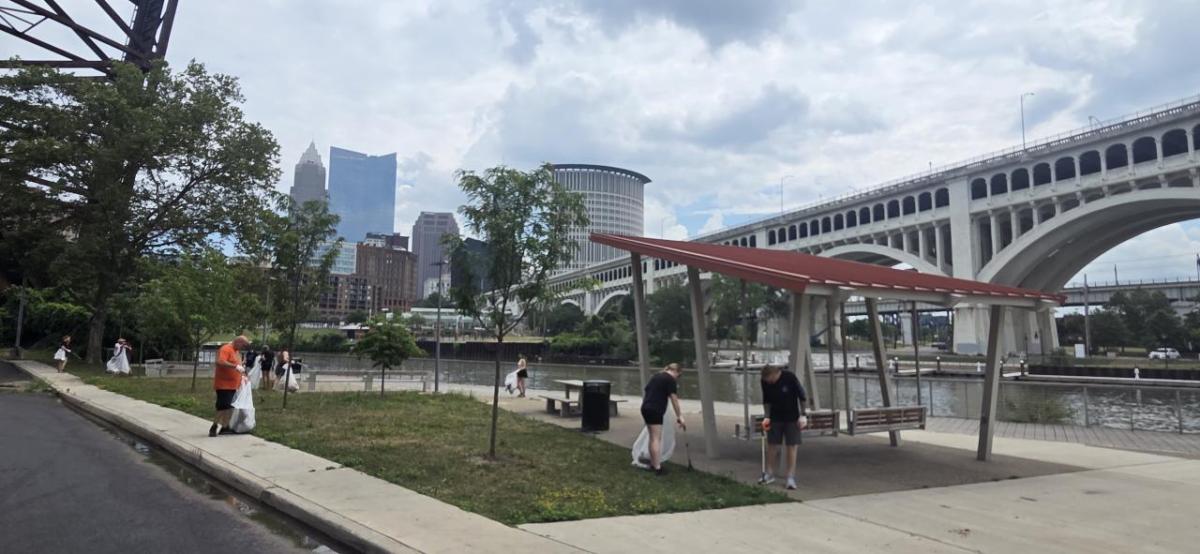 AEG employee volunteers gathered along the Cuyahoga River, armed with gloves and trash grabbers.