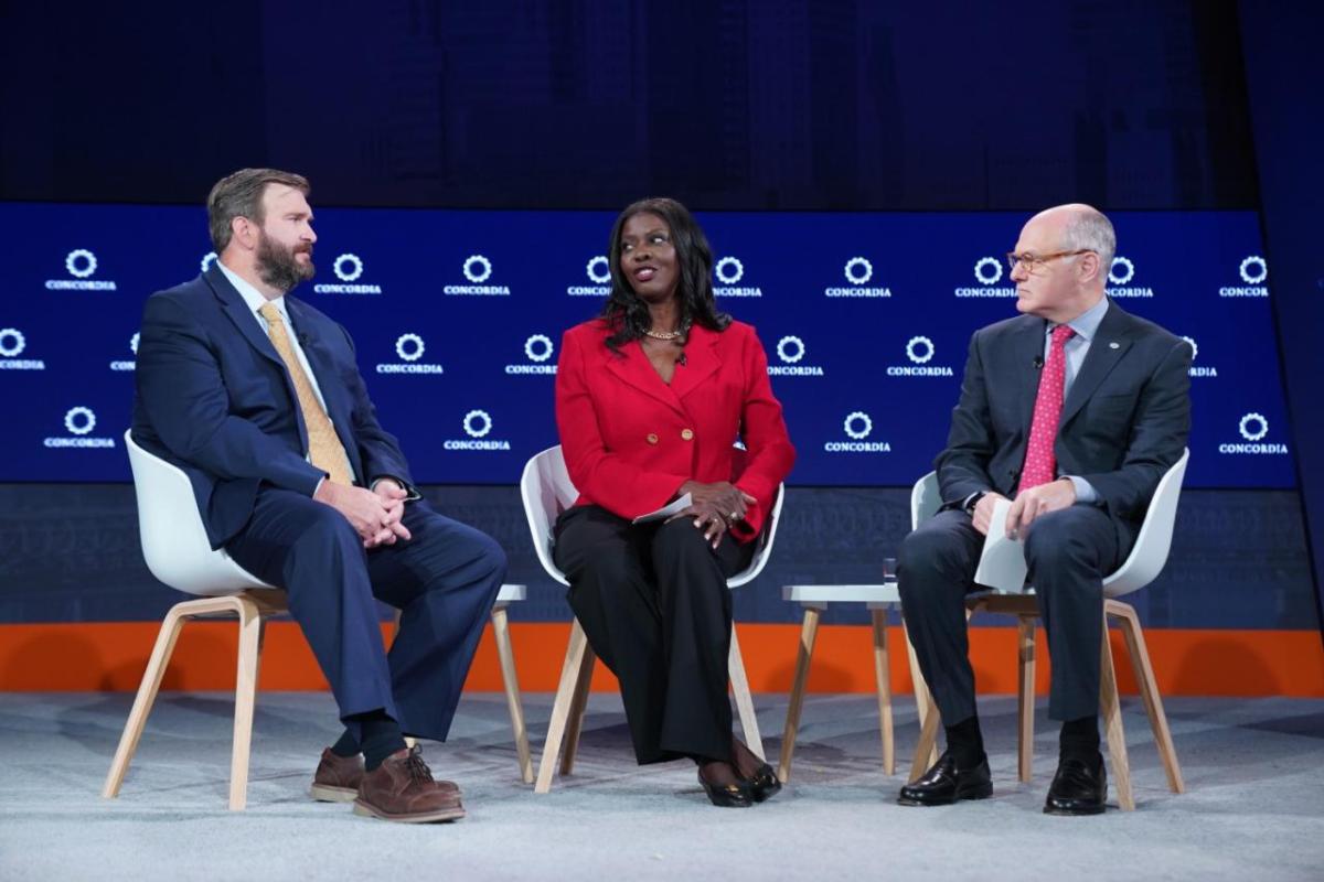 Three people sitting down and talking together