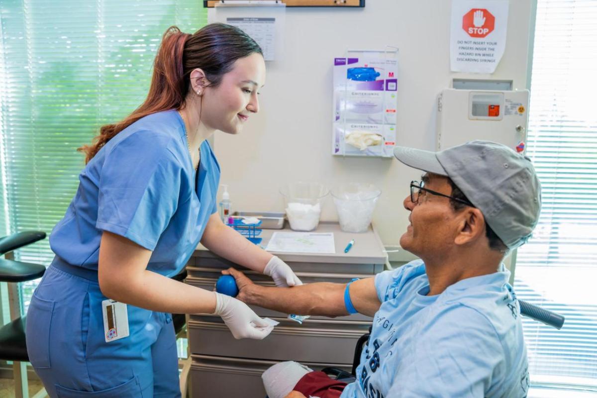 Lab Technician prepares to draw blood from a patient