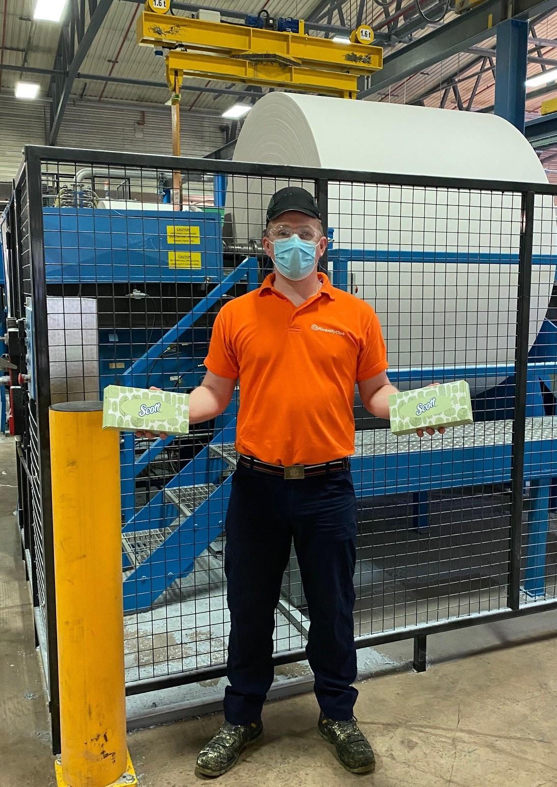 An employee holds Scott® tissues at Kimberly-Clark's Flint manufacturing facility in the UK.