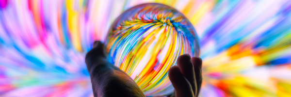 A person holding a colourful glass ball