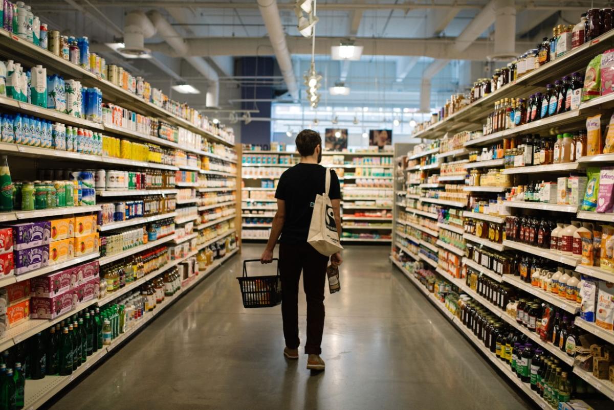 Fairtrade America reveals top consumer trends for 2022, predicting a need for brands to make good on their sustainability and human rights claims, and make it easier for shoppers to find ethically-sourced goods. person grocery shopping