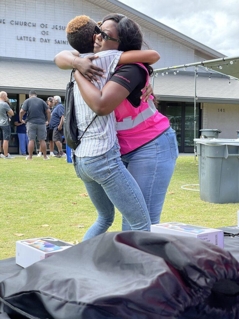 Community support, employee hugging a person in need