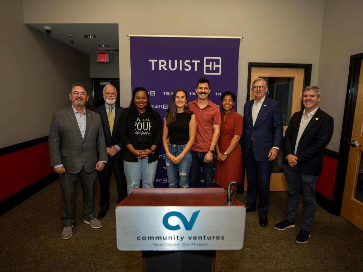 Community leaders gathered at Chef Space to celebrate a $500,000 grant from Truist Foundation to Community Ventures on Friday, Oct. 27, 2023, to support small businesses throughout Kentucky. (L-R: Calvin Barker, Tri-States Regional President, Truist Financial; Kevin Smith, President and CEO, Community Ventures; Yasmine Fleming, Owner, Luxe and Ash Candle Co.; Danielle Wood, Co-founder, Elixir Kombucha; Corey Wood, Co-founder, Elixir Kombucha; Shirie Hawkins, President, Everything Equity; Bill Rogers, Chairman and CEO, Truist Financial; and Jeff O’Brien, Executive Director with Louisville Metro Government’s Cabinet for Economic Development) Community leaders standing together