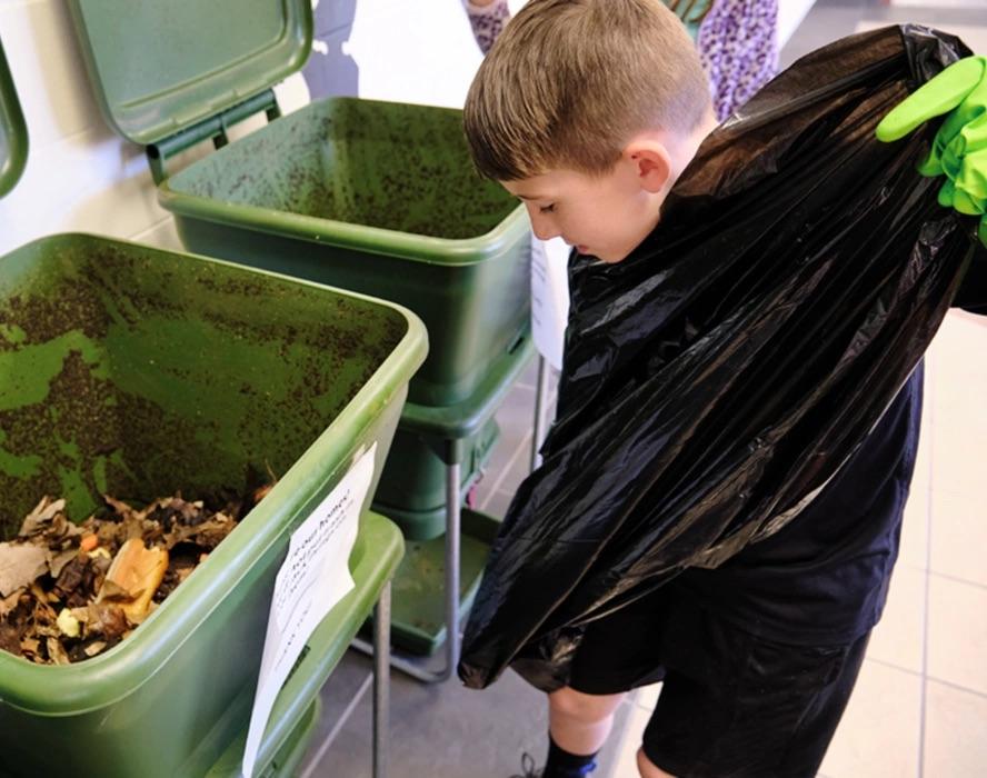 kid working on composting