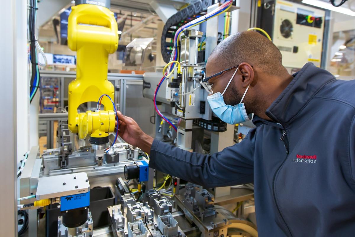 Worker at Rockwell Automation guiding machine