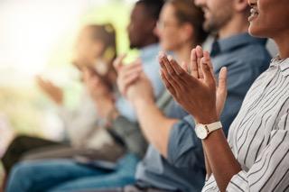 People clapping hands in support of speech or presentation