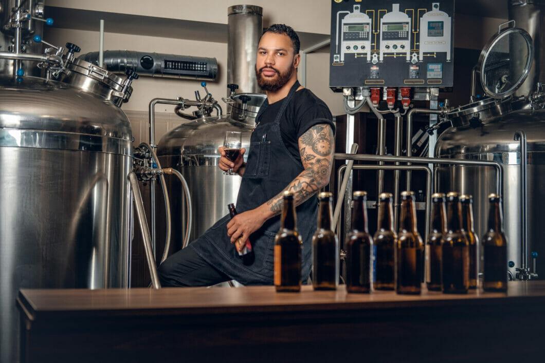 Photo of bartender behind a craft beer bar, looking into the camera