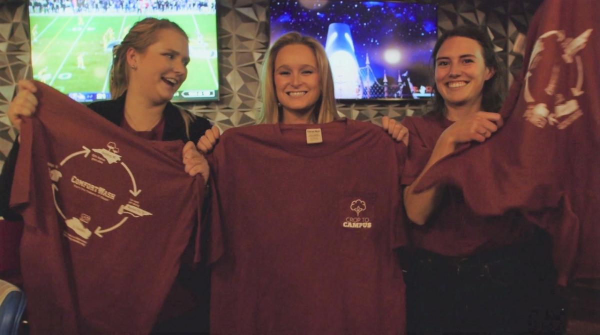 North Carolina State University students Sydney Parker, Katy Powers and Mamie Trigg present their self-designed T-shirts to campus students during a wrap party for “Crop to Campus,” a seven-part, minidocumentary that follows the students on a step-by-step exploration of making a sustainable T-shirt. (Photo: Business Wire)