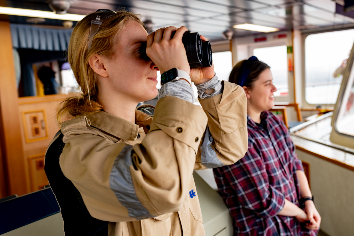 people looking out with binoculars