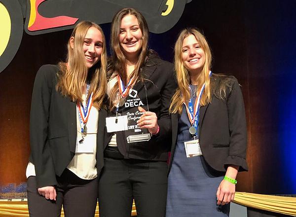 Students Alex Glaser, Olivia Perrini, and Maria DiRusso pose with their DECA award.