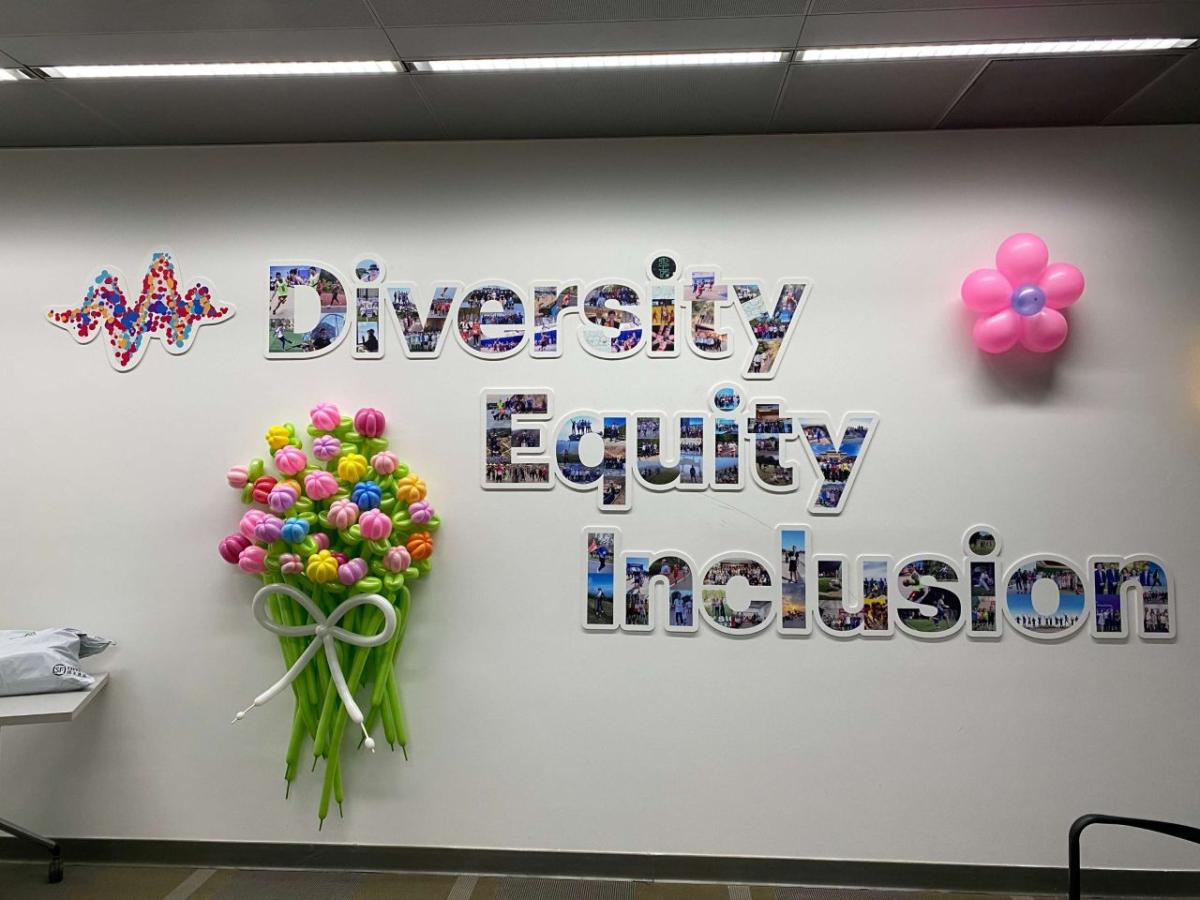 Wall display with the words "Diversity Equity Inclusion" made out of photos