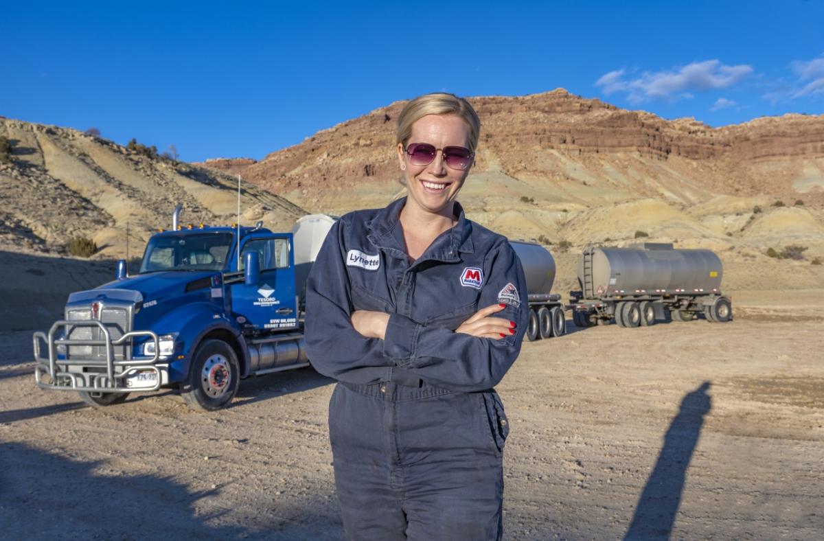 woman standing with truck in background 