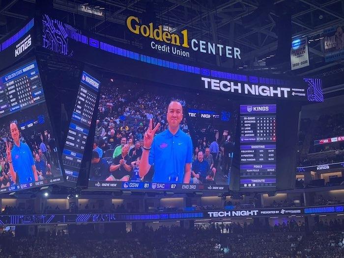 Tom Tran being honored by the Sacramento Kings. Shown on a video monitor at a game.