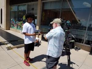 Schenectady student Damonni Farley shows the solar car built during the National Grid Summer Trades Camp in Schenectady, NY.