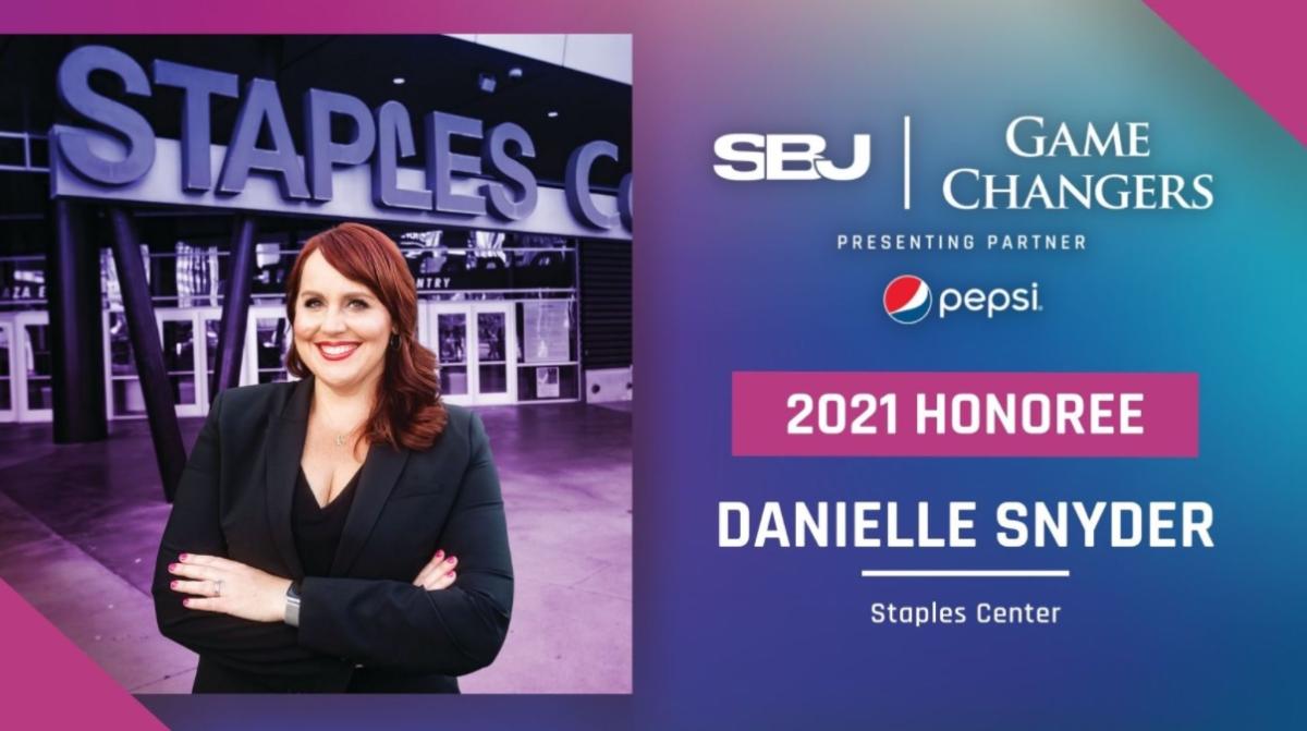 AEG’s Danielle Snyder, senior vice president of guest services and security at STAPLES Center, has been named an honoree of SportsBusiness Journal’s 2021 Game Changers “Women in Sports Business.” Danielle Snyder stands before the STAPLES Center sign and smiles.