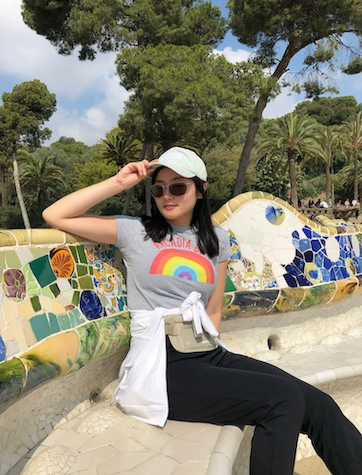 Dannie seated on a colorful bench.