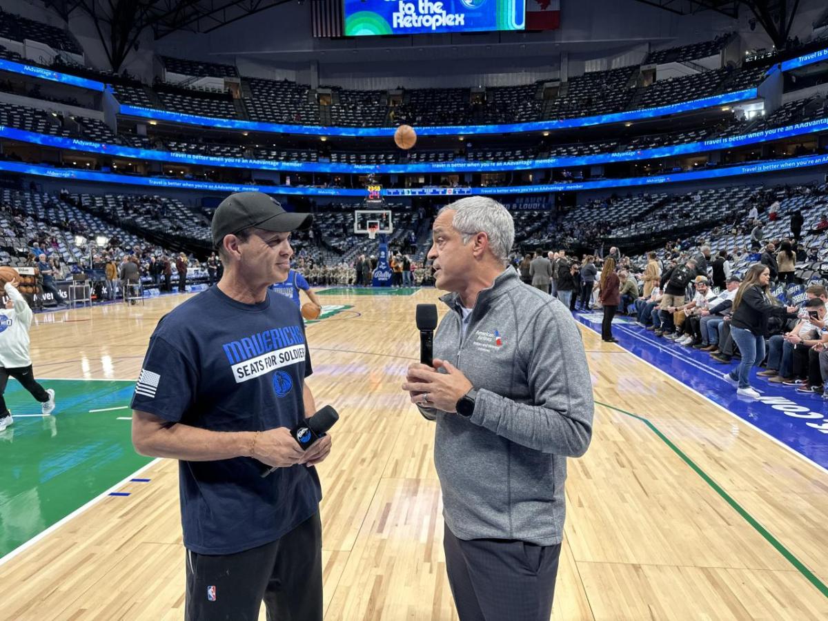 Two men talking on mics on the basketball court