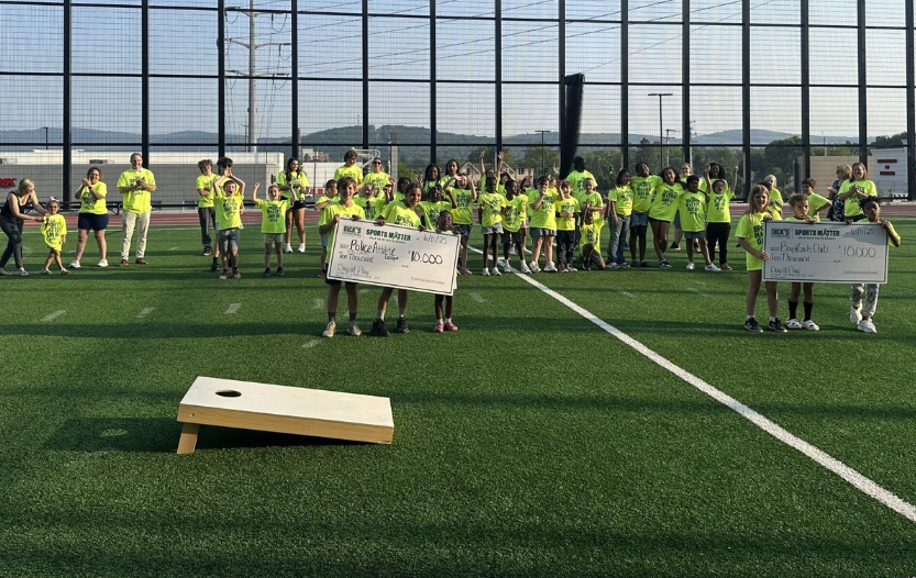 Day of Play participants shown with the grant checks from DICK'S.