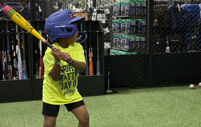A young batter preparing for a pitch.