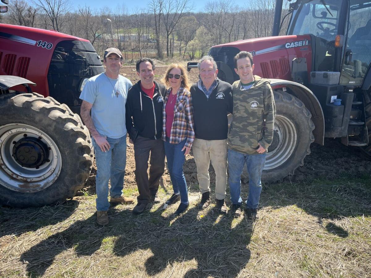 Group photo in front of two tractors at De Francesco Farm