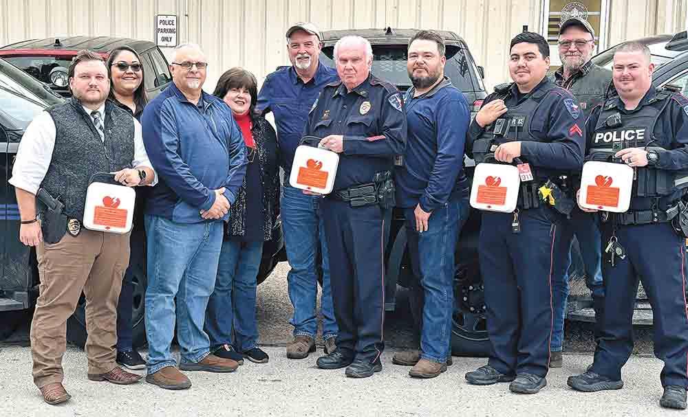 Group of first responders holding defibrillators 