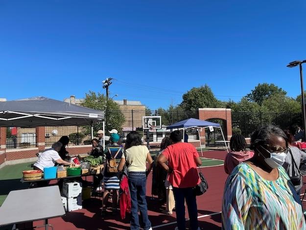 People lined up at the Delavan-Grider Farmers market to buy fresh produce.