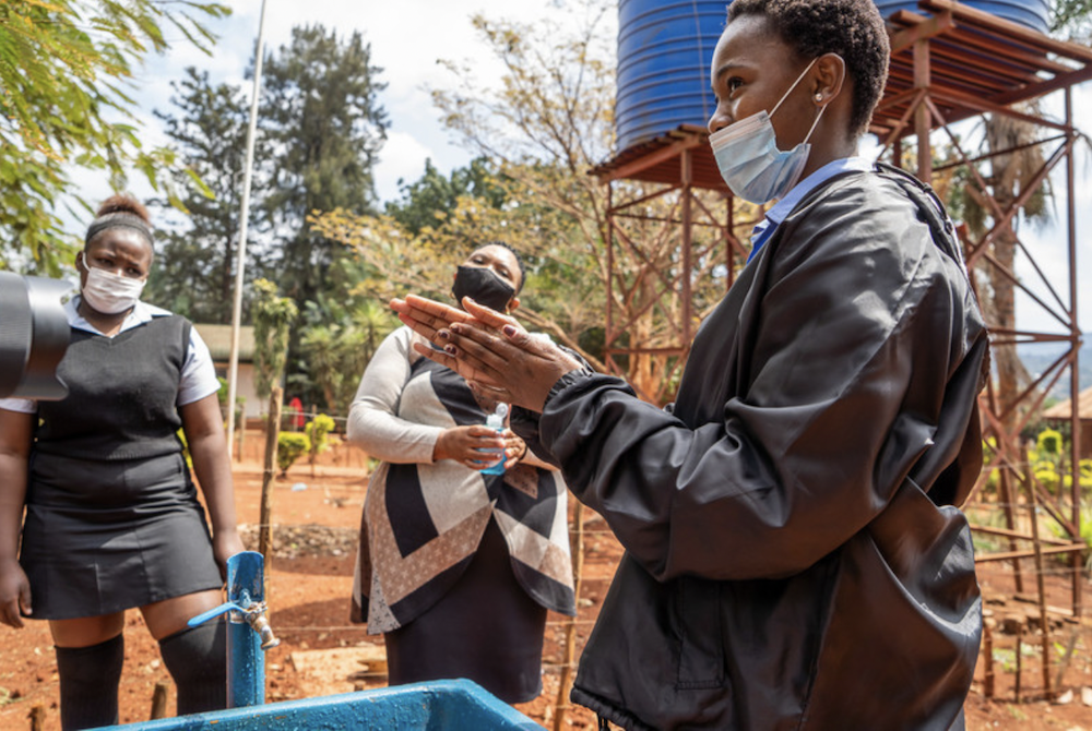 Mrs Ratshisevhe NC, a senior educator who is responsible for sanitation, hygiene and menstrual health at Ligege Secondary School in South Africa, teaches good handwashing practices at the school's new handwashing station.