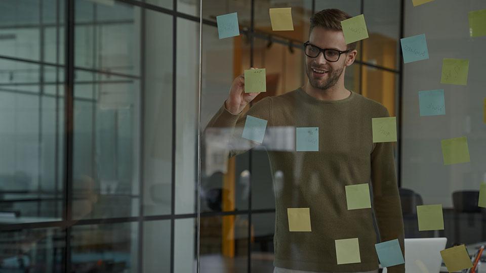 Person sticking notes to glass