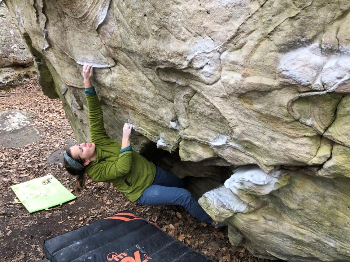 Alexandra Toth climbing a boulder