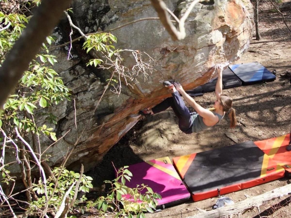 Alexandra Toth climbing a boulder