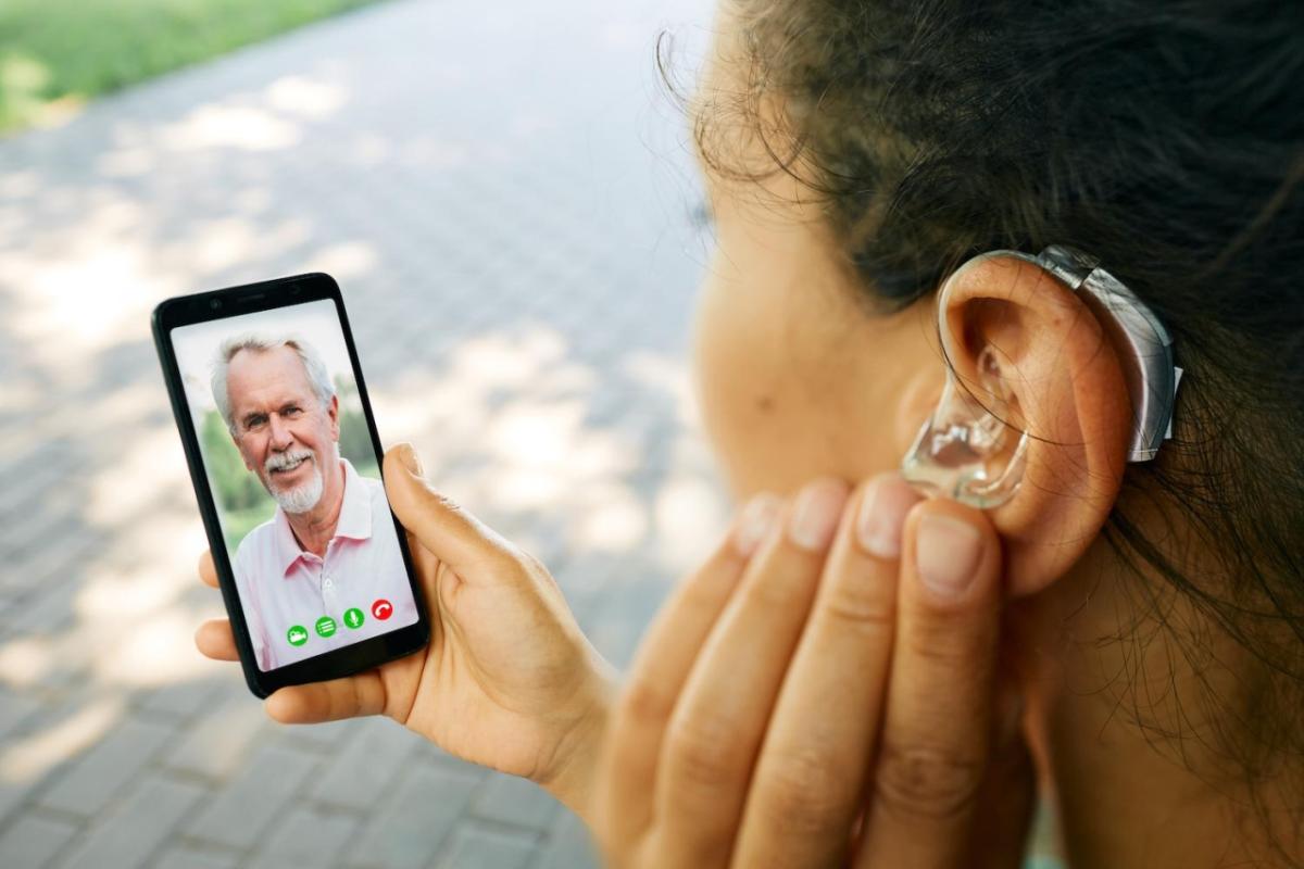 person with hearing aid talking on video call