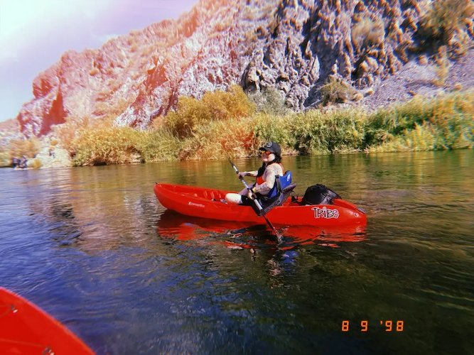 Dina in a kayak on a river.