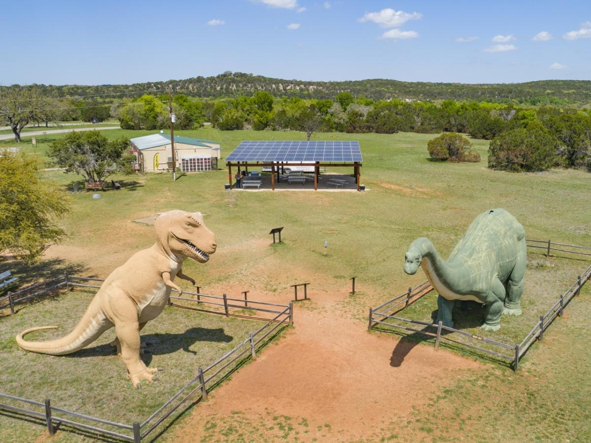 The solar panel pavilion funded by Green Mountain Energy provides a shaded view of dinosaur models at Dinosaur Valley State Park