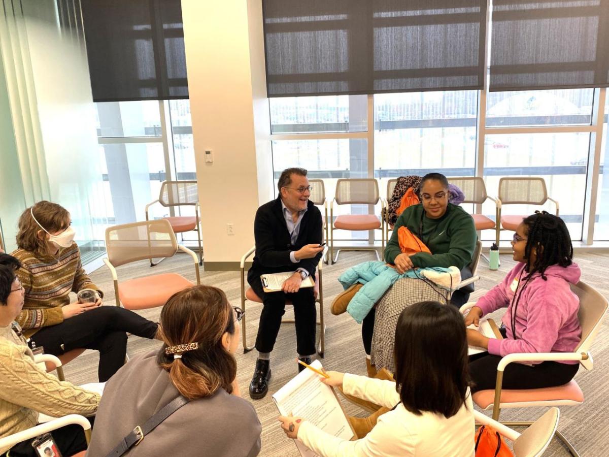 Group of people sitting on chairs in a circle