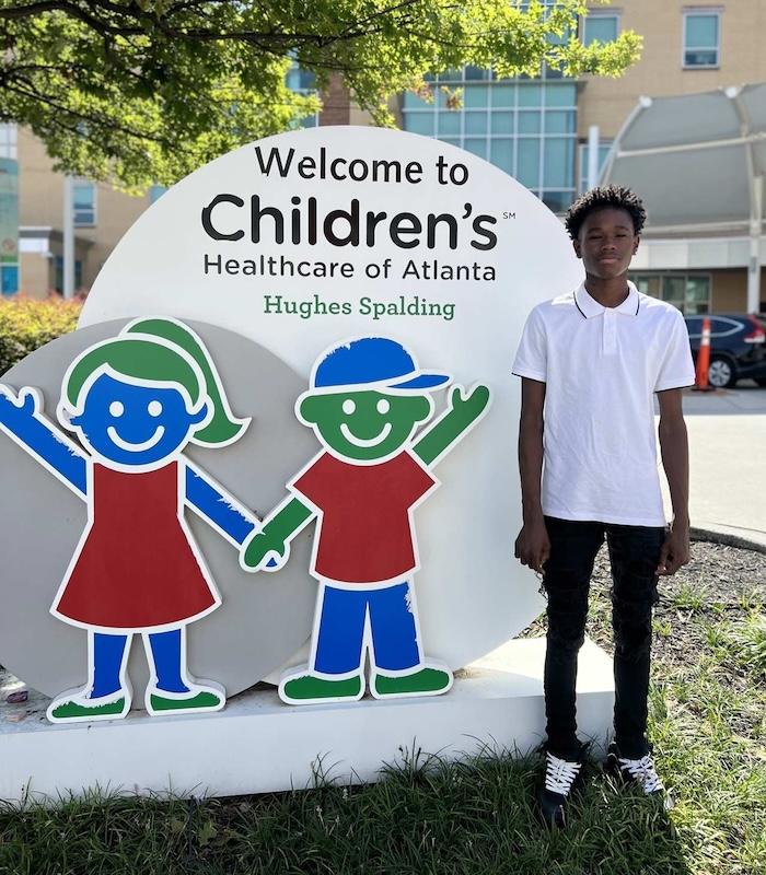 Learning to fly; Kordell shown in front of the Children's Healthcare of Atlanta.