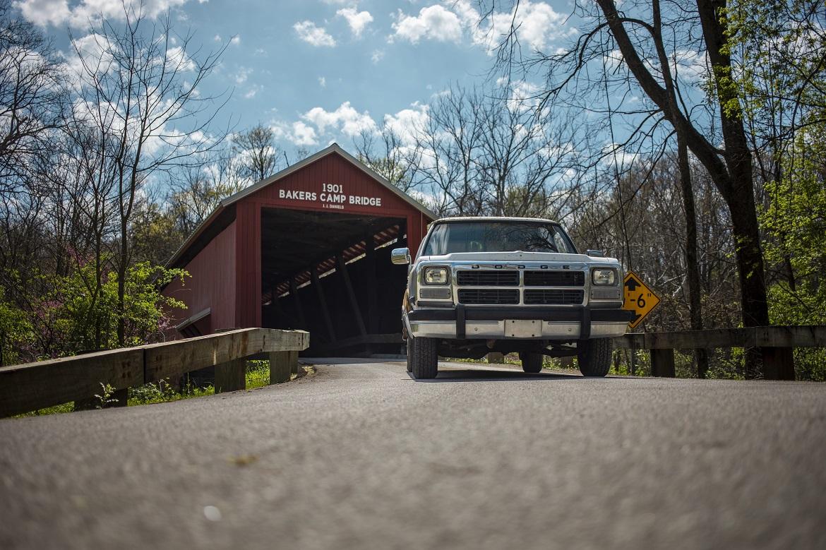 Car driving under covered bridge
