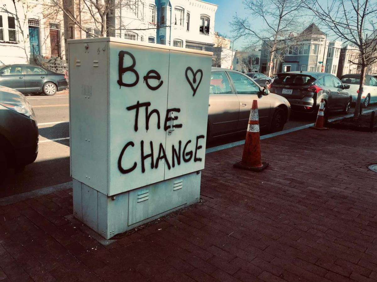 "Be the change" spray painted outside