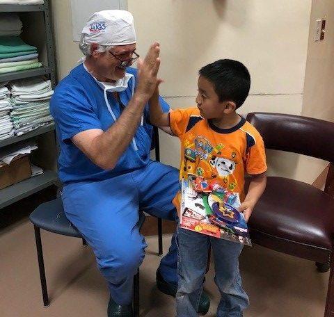 Doctor high fiving child