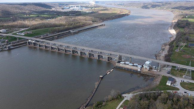 aerial view of a hydroelectric dam spanning across a wide river