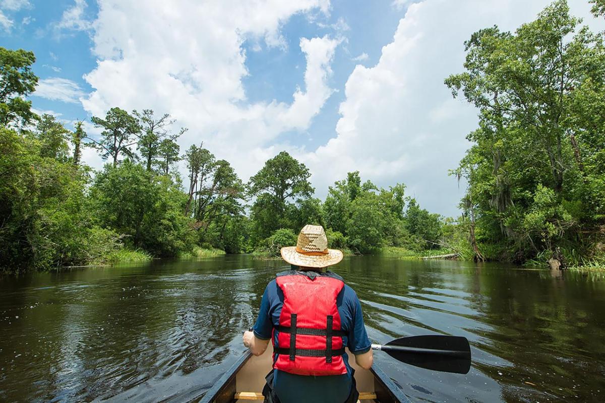 person kayaking down a river