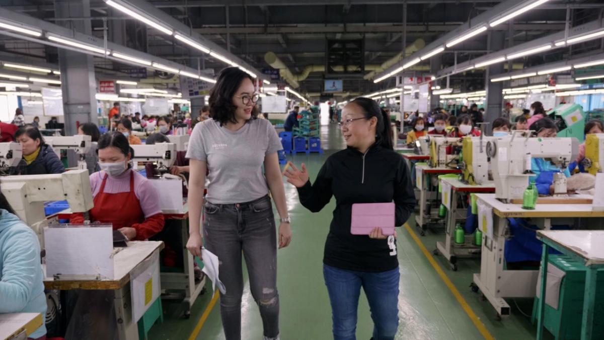 two women walking in factory