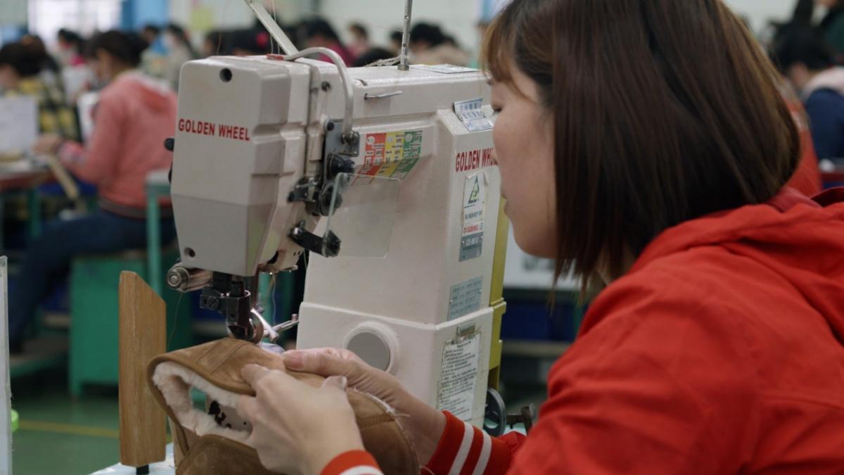 woman sewing boot at sewing machine