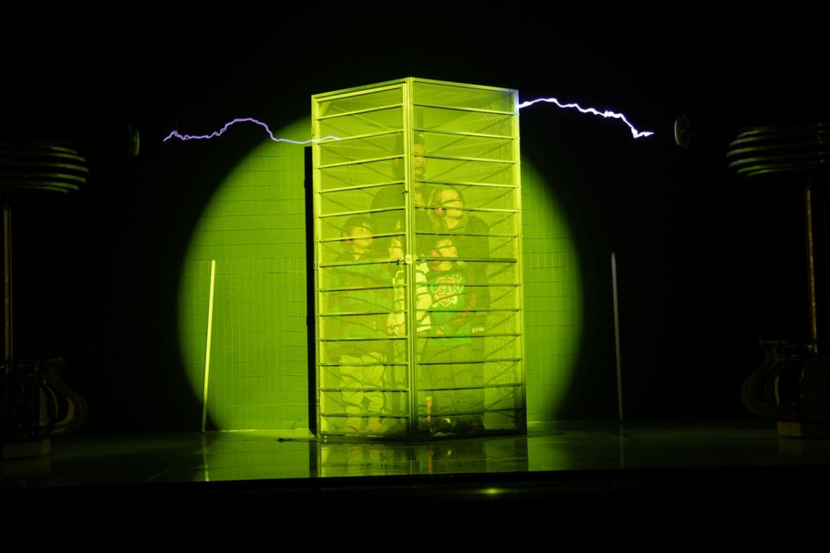 A family takes part in the Faraday Cage live science experiment. Photo Courtesy of the Rochester Museum & Science Center.