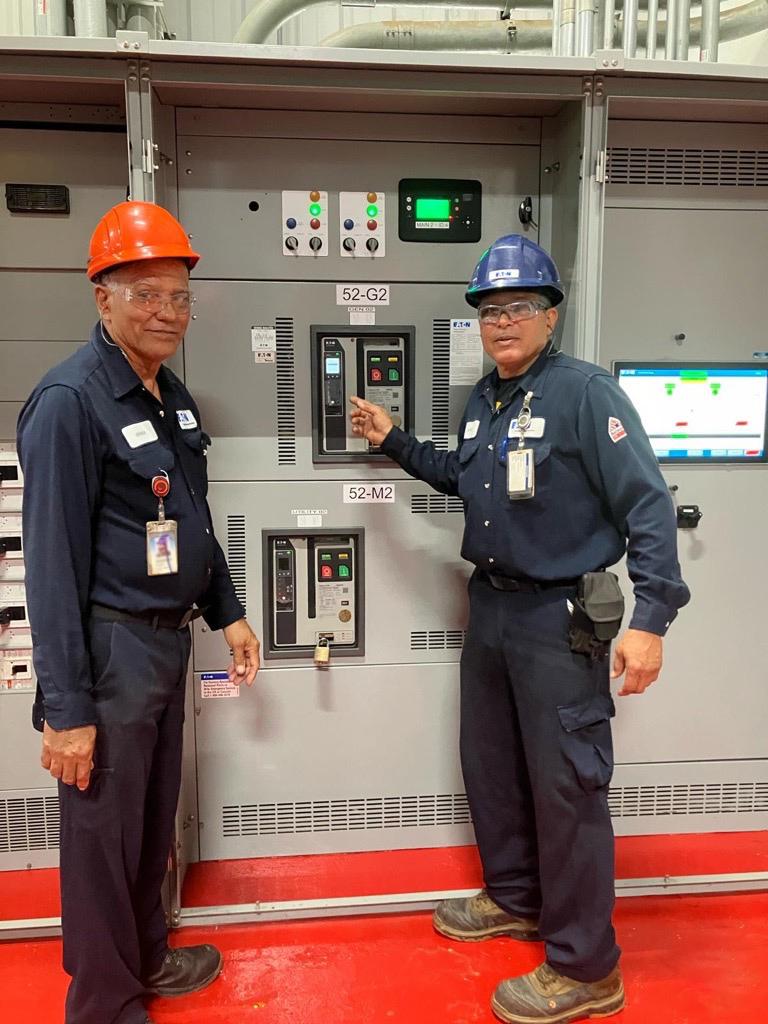 Eaton employees standing with circuit breakers 