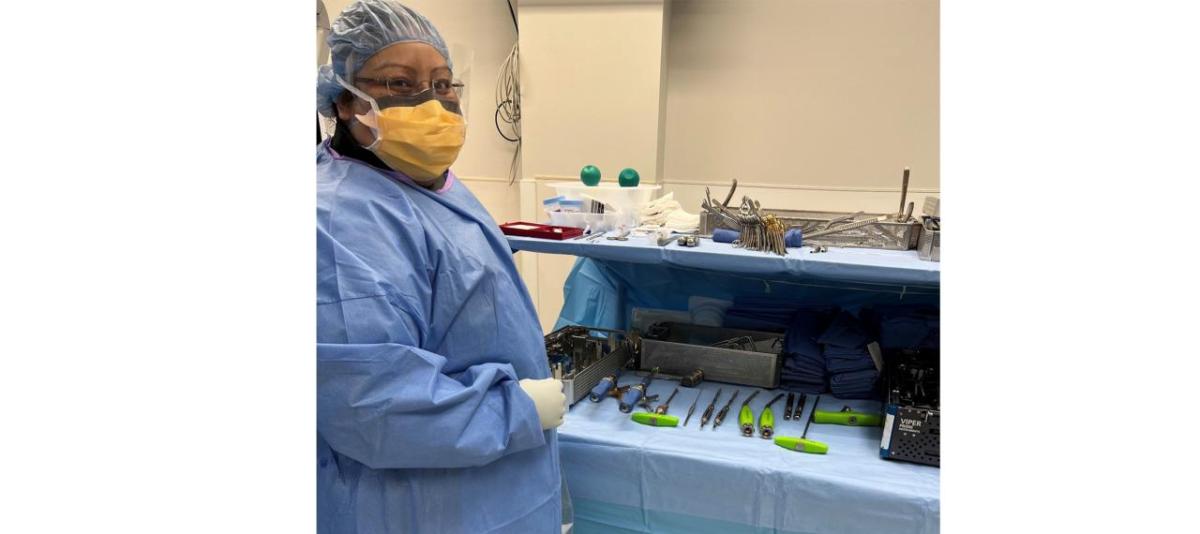 Elizabeth Arroyo Gomez stood next to a table of health care technology tools