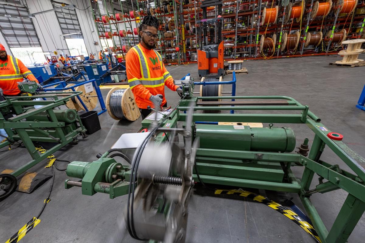 Wesco employee cutting spool wire.