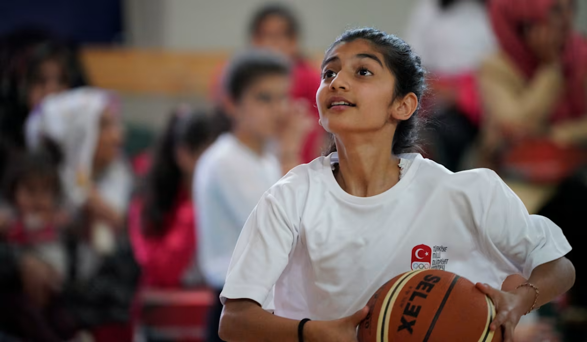 Student shooting basketball