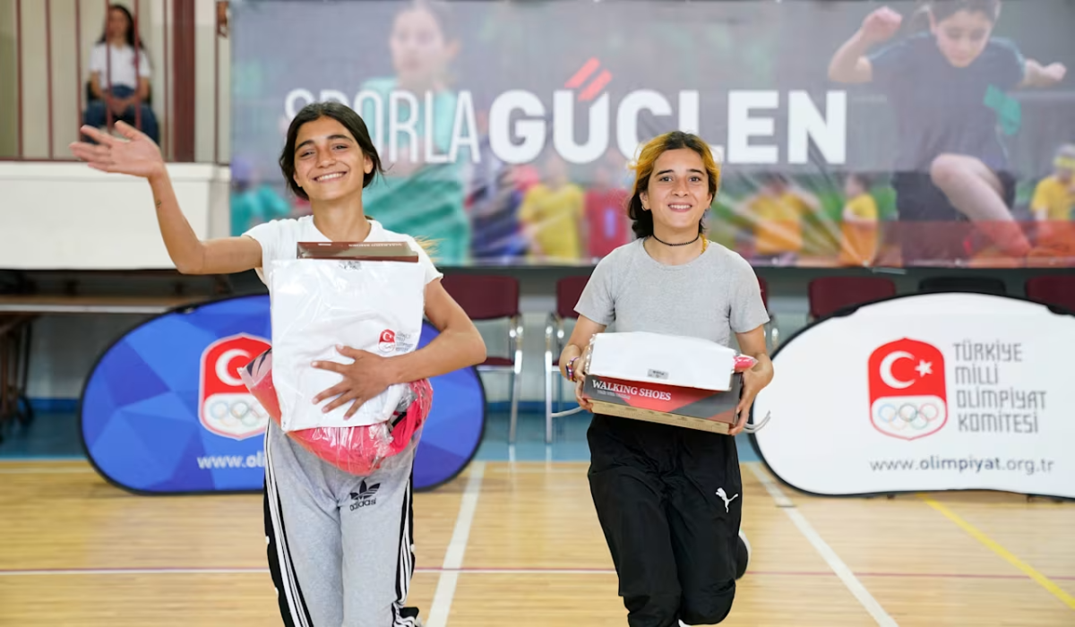 2 students smiling with shoe boxes 